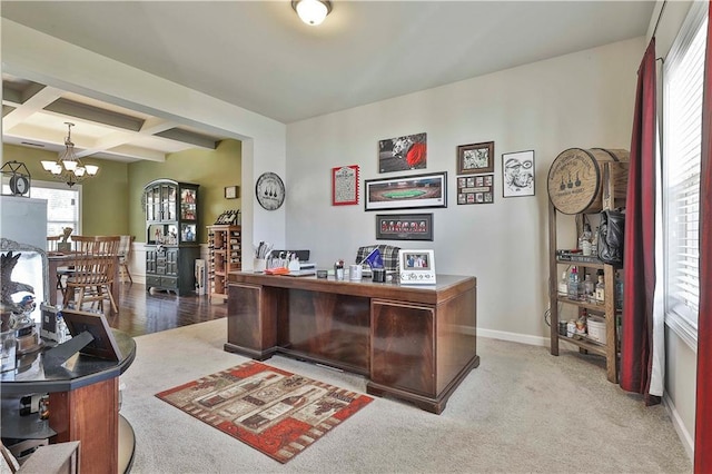 office with beam ceiling, light carpet, coffered ceiling, and an inviting chandelier