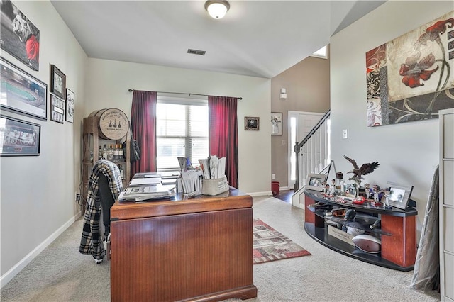 office space with light colored carpet and lofted ceiling