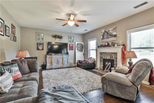 living room featuring a fireplace, dark hardwood / wood-style floors, and ceiling fan