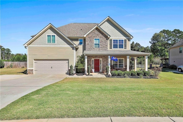 craftsman inspired home featuring a porch, a garage, and a front lawn