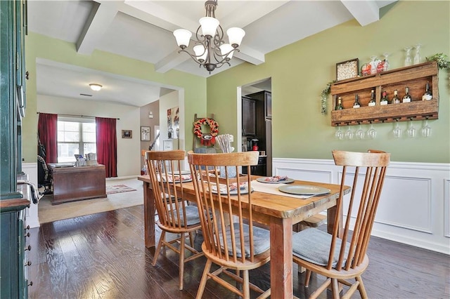 dining space featuring beam ceiling, dark hardwood / wood-style floors, and an inviting chandelier