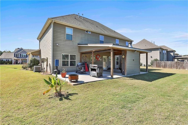 back of house with a lawn, a patio area, and cooling unit