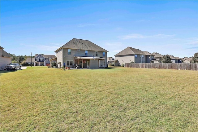 rear view of house with a lawn