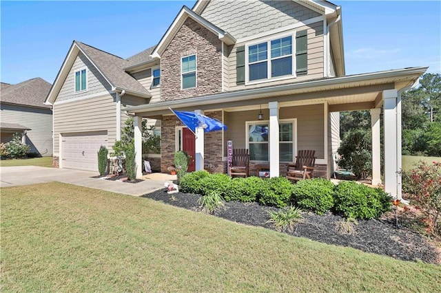 craftsman inspired home featuring a front lawn, a porch, and a garage