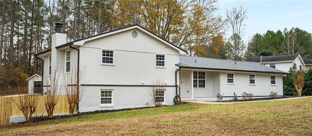 rear view of house with a lawn