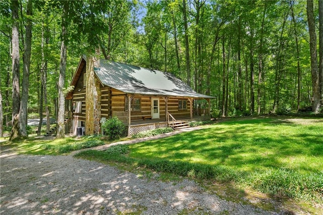1975 Mack Rd, Douglasville, GA 30135 - view of front of property featuring a porch, log exterior, a chimney, a front yard, and metal roof
