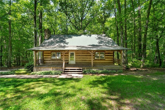 1975 Mack Rd, Douglasville, GA 30135 - view of front facade with a chimney, a front yard, a wooden deck, and metal roof