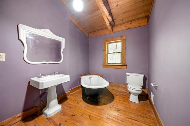 1975 Mack Rd, Douglasville, GA 30135 - bathroom with hardwood / wood-style flooring, toilet, a freestanding tub, wooden ceiling, and baseboards
