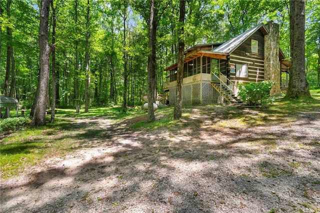 1975 Mack Rd, Douglasville, GA 30135 - view of yard featuring a sunroom, stairs, and a wooded view