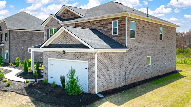 view of side of property with a lawn and a garage