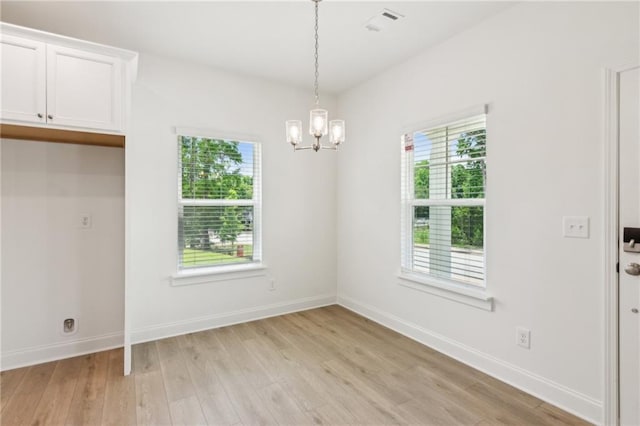 165 Mill Center Blvd Unit 108, Athens, GA 30606 - unfurnished dining area with a chandelier, light wood-style flooring, and baseboards