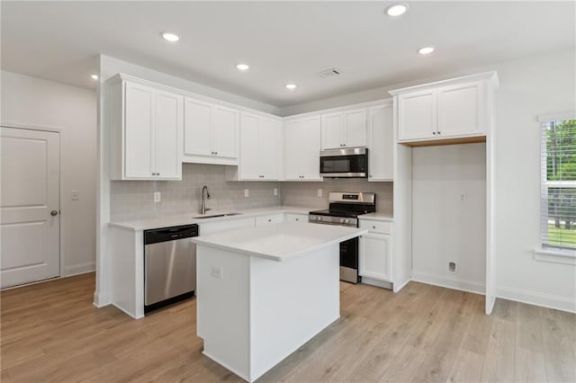 165 Mill Center Blvd Unit 108, Athens, GA 30606 - kitchen featuring stainless steel appliances, tasteful backsplash, light countertops, white cabinets, and recessed lighting