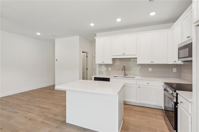 165 Mill Center Blvd Unit 108, Athens, GA 30606 - kitchen featuring stainless steel appliances, a sink, decorative backsplash, light countertops, and recessed lighting