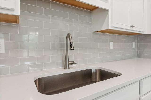 165 Mill Center Blvd Unit 108, Athens, GA 30606 - kitchen view of a sink, tasteful backsplash, and white cabinetry
