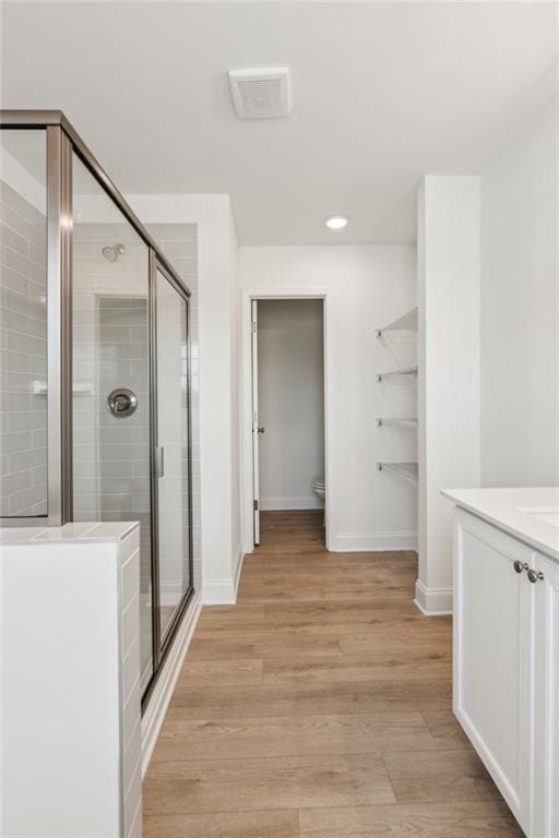 165 Mill Center Blvd Unit 108, Athens, GA 30606 - full bath featuring a stall shower, vanity, baseboards, wood finished floors, and toilet