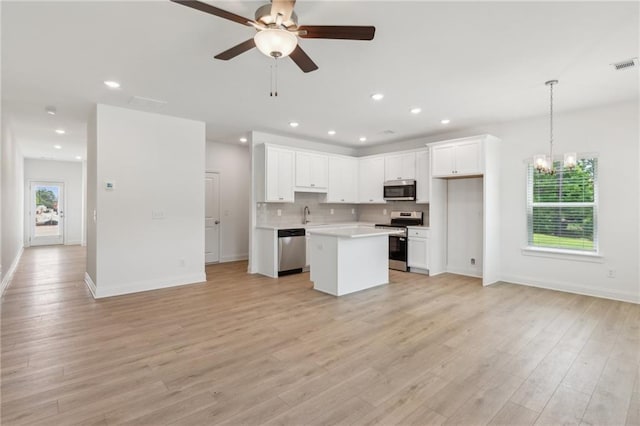 165 Mill Center Blvd Unit 108, Athens, GA 30606 - kitchen with appliances with stainless steel finishes, open floor plan, white cabinetry, light countertops, and recessed lighting