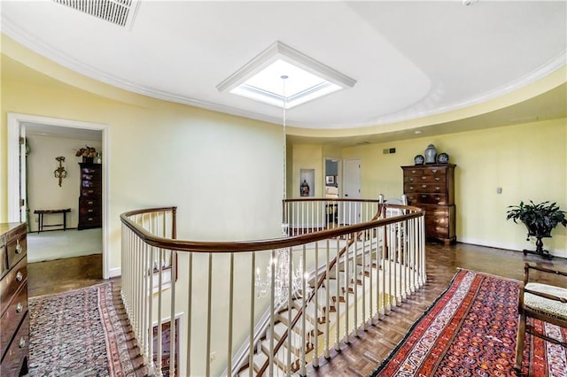 hall featuring crown molding, a skylight, and dark parquet floors