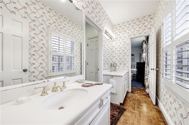 bathroom with vanity and parquet floors