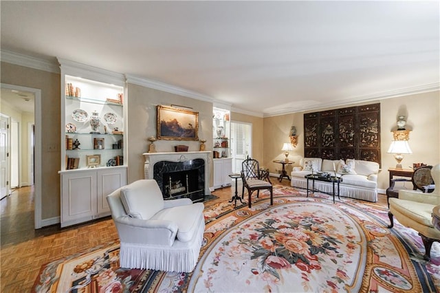 living room featuring a high end fireplace, parquet flooring, and ornamental molding