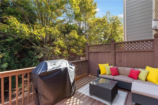 wooden deck with area for grilling and an outdoor hangout area