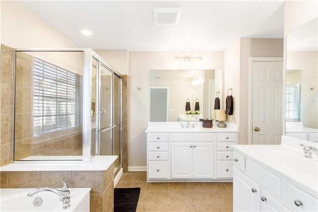 bathroom with tile patterned floors, plenty of natural light, and plus walk in shower