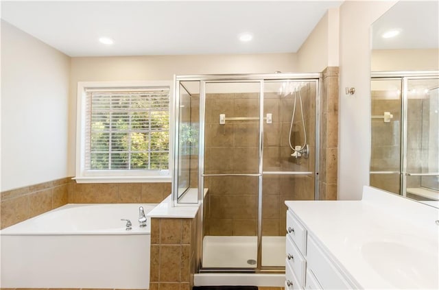 bathroom with vanity and independent shower and bath