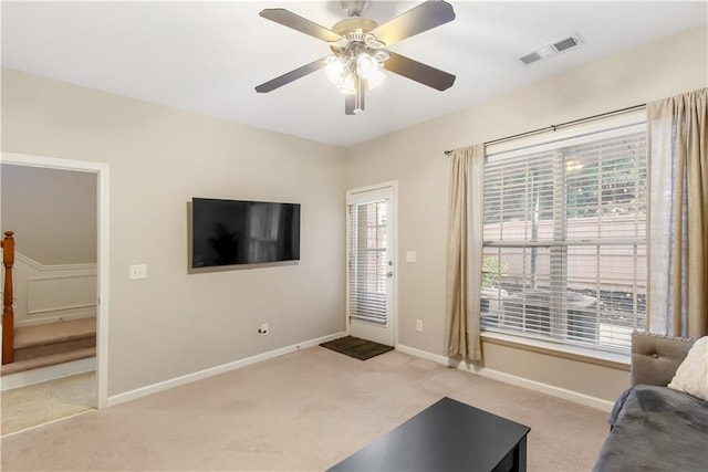 carpeted living room featuring ceiling fan and a healthy amount of sunlight