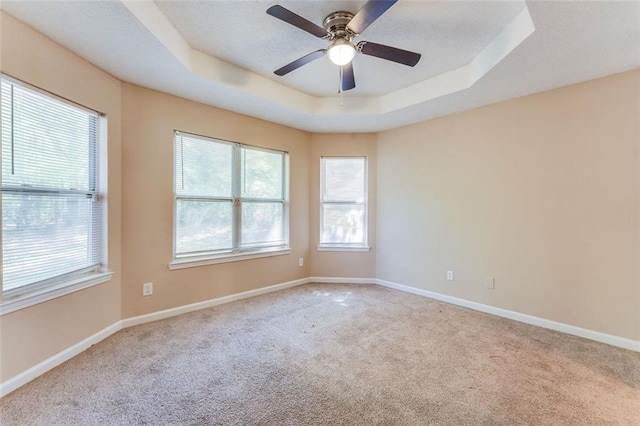 179 Glynn Addy Dr, Stockbridge, GA 30281 - unfurnished room with a raised ceiling, carpet floors, and ceiling fan
