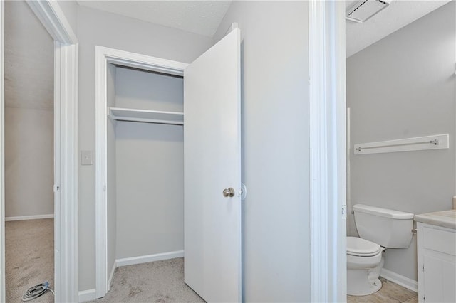 51 Ezzard St, Lawrenceville, GA 30046 - bathroom with toilet, vanity, and baseboards