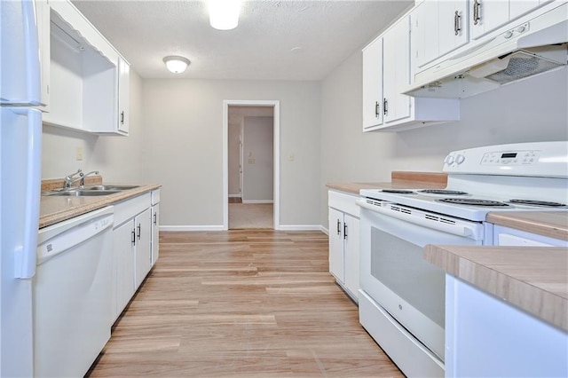 51 Ezzard St, Lawrenceville, GA 30046 - kitchen with white appliances, under cabinet range hood, a sink, light countertops, and white cabinets