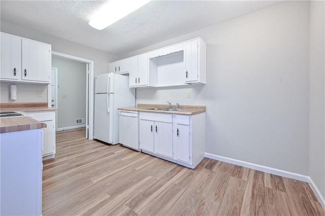 51 Ezzard St, Lawrenceville, GA 30046 - kitchen featuring white appliances, a sink, light wood-style floors, baseboards, and a textured ceiling