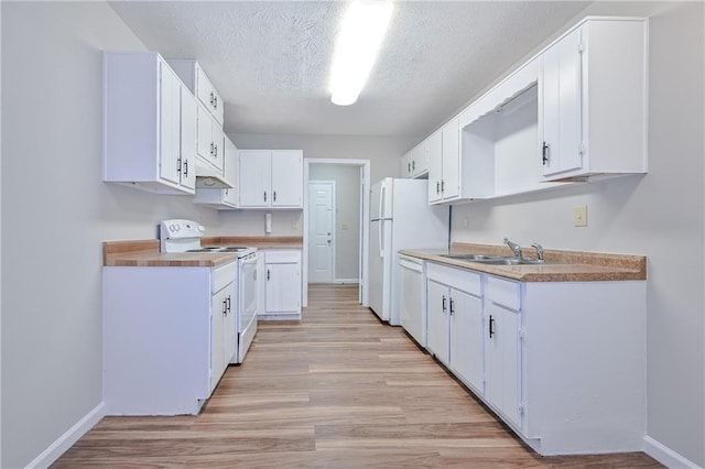 51 Ezzard St, Lawrenceville, GA 30046 - kitchen featuring white appliances, a sink, under cabinet range hood, light wood-type flooring, and white cabinets