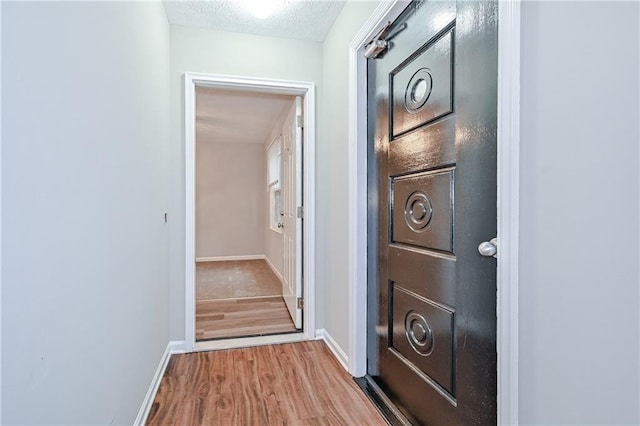 51 Ezzard St, Lawrenceville, GA 30046 - corridor featuring wood finished floors, baseboards, and a textured ceiling