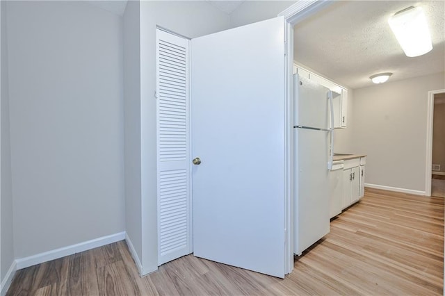 51 Ezzard St, Lawrenceville, GA 30046 - kitchen featuring white appliances, white cabinetry, light wood finished floors, baseboards, and light countertops