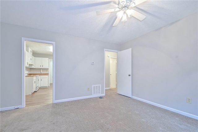 51 Ezzard St, Lawrenceville, GA 30046 - unfurnished bedroom featuring light colored carpet, baseboards, and a ceiling fan