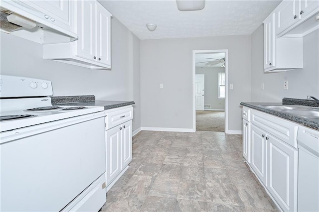 51 Ezzard St, Lawrenceville, GA 30046 - kitchen with white appliances, a sink, under cabinet range hood, dark countertops, and white cabinets