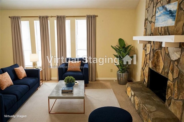 living room featuring light carpet and a stone fireplace