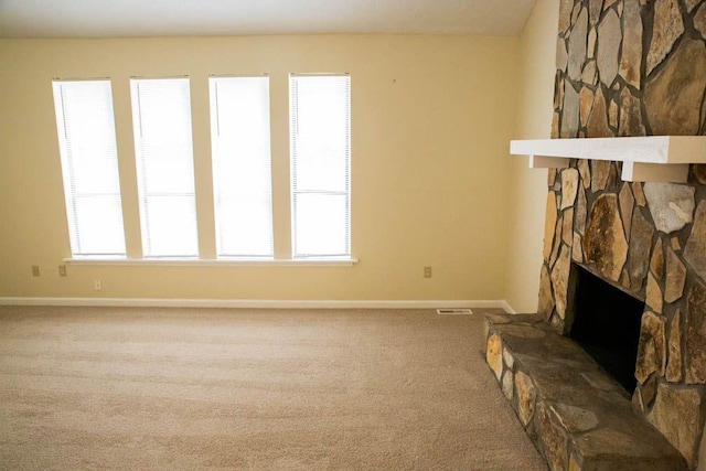 carpeted living room featuring a fireplace