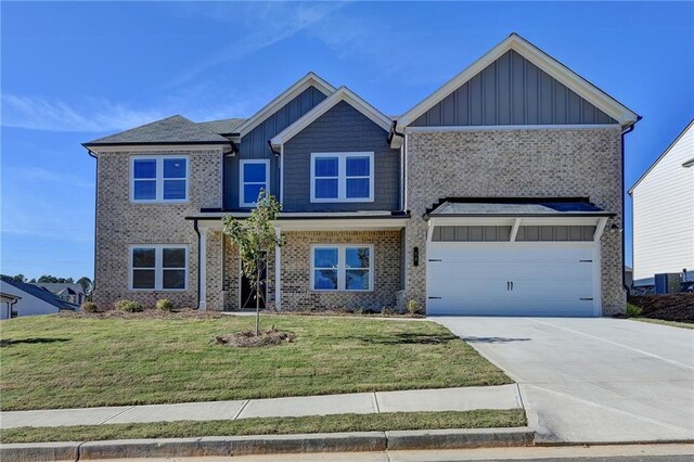 58 Longhorn Way, Auburn, GA 30011 - craftsman inspired home with board and batten siding, driveway, a front yard, a garage, and brick siding