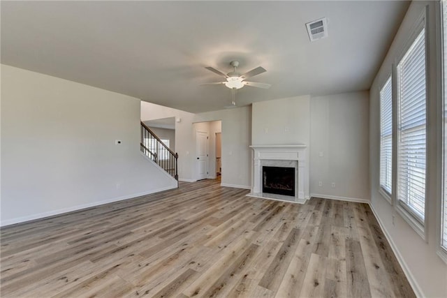 58 Longhorn Way, Auburn, GA 30011 - unfurnished living room with a ceiling fan, visible vents, light wood finished floors, and a high end fireplace
