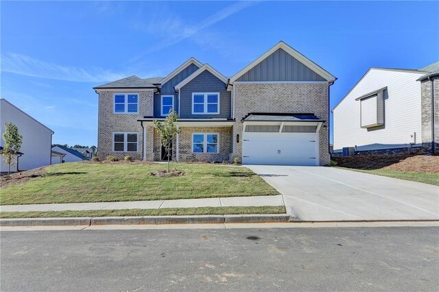 58 Longhorn Way, Auburn, GA 30011 - craftsman-style house featuring an attached garage, a front lawn, brick siding, board and batten siding, and driveway