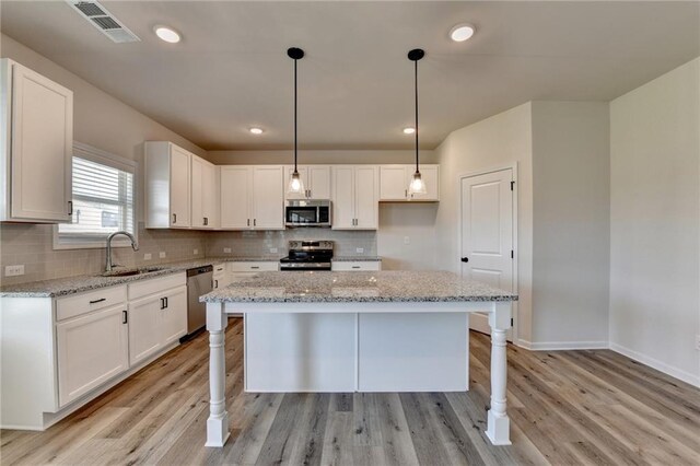 58 Longhorn Way, Auburn, GA 30011 - kitchen featuring white cabinets, stainless steel appliances, visible vents, and a sink