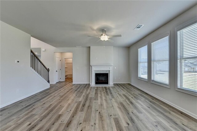 58 Longhorn Way, Auburn, GA 30011 - unfurnished living room featuring ceiling fan, light wood finished floors, stairs, baseboards, and visible vents