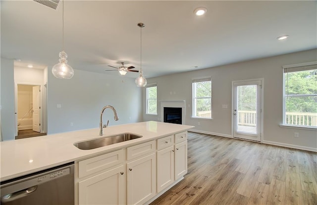 kitchen with a sink, visible vents, stainless steel dishwasher, and a healthy amount of sunlight