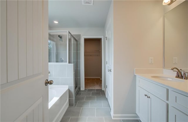 576 Teversham Dr, Mcdonough, GA 30253 - bathroom featuring a shower stall, vanity, a garden tub, and tile patterned flooring