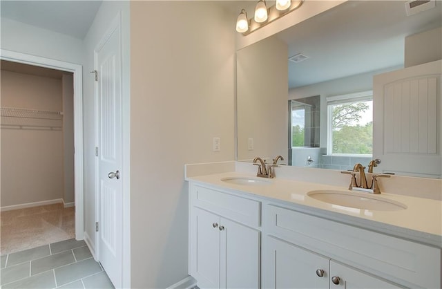 bathroom featuring double vanity, a sink, and visible vents