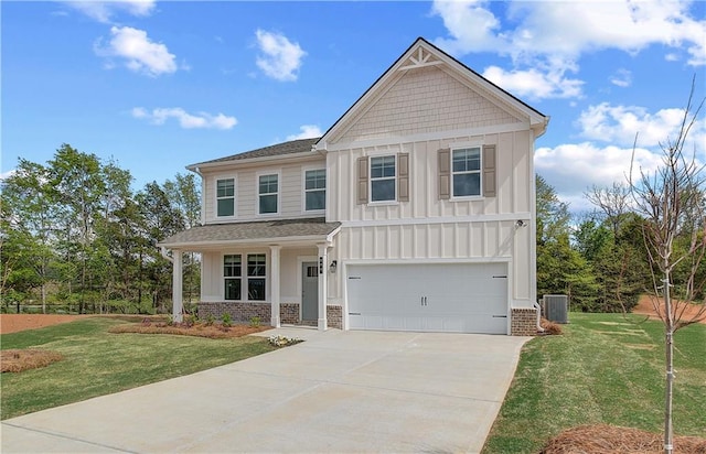 craftsman inspired home with board and batten siding, driveway, a garage, and a front yard