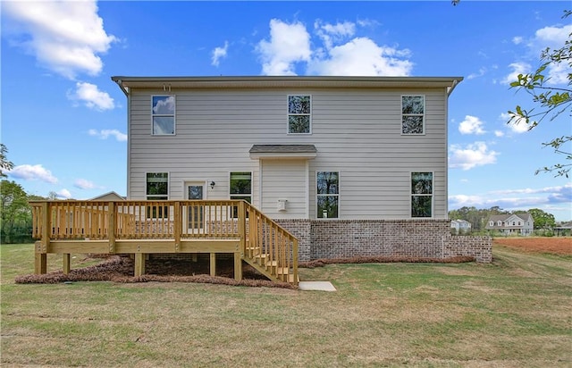 back of property with a yard, a deck, and stairs