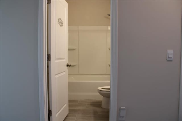 bathroom featuring hardwood / wood-style flooring and toilet