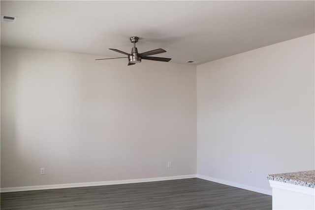 spare room with ceiling fan and dark wood-type flooring